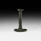 Post Medieval Biedermeier Candlestick
19th century AD. A hollow-formed bronze candlestick with flared drip-tray and raised rim, slightly balustered b...