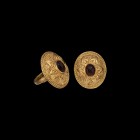 Post Medieval Gold Ring with Garnet
19th century AD. A gold ring comprising a hollow-formed elliptical-section hoop with filigree coils to the should...