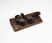 Post Medieval Lock Mechanism
17th century AD. A handmade lock mechanism mounted on a later timber block, with spring and catch, reinforced catch; ins...