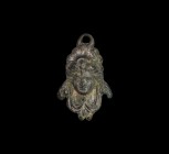 Post Medieval Pendant with Mask
18th century AD. A bronze plaque pendant with high-relief facing female mask and swags below. 7.9 grams, 33mm (1 1/4"...