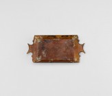 Roman Grand Tour Glass Tray
19th century AD or earlier. An amber-coloured glass tray, rectangular in plan with chamfered sides, scooped short edges w...