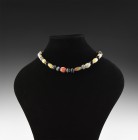 Post Medieval Banded Agate Bead Necklace
20th century AD. A restrung choker necklace composed of barrel-shaped banded agate beads, spherical glass be...
