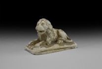 Roman Grand Tour Limestone Lion
19th century AD. A carved limestone statuette of a reclining lion on a rectangular base, head erect with open mouth, ...