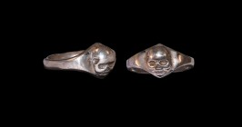 Post Medieval Silver Skull Ring
19th century AD. A silver finger ring with substantial hoop, scaphoid bezel with skull modelled in the half-round, he...