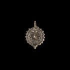 Post Medieval Silver Pendant with Boss
18th-19th century AD. A silver pendant with pelletted border, raised boss with petal decoration, suspension lo...