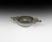 Jacobean Pewter Porringer
17th century AD. A pewter porringer with low basal ring, broad bowl with small external lip, openwork lattice handle to eac...