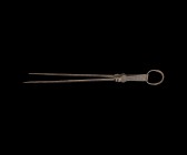 Post Medieval Fire Tongs
18th-19th century AD. A pair of iron fire tongs comprising two long tapering arms each with ribbing and beast-head panel, pi...