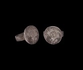 Byzantine Silver Ring with Cross
6th-7th century AD. A silver finger ring comprising a flat reeded hoop supporting a discoid bezel with incised borde...