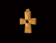 Post Medieval Gold Cross Pendant with Gemstone
19th-20th century AD. A hollow-formed gold cross pendant with expanding arms, applied wire decoration ...