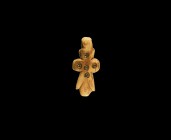 Coptic Bone Cross Pendant
7th century AD. A carved bone cruciform pendant with pierced lug, three stub arms and larger lower leg with lateral flanges...