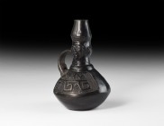 Pre-Columbian Figural Vessel
1st millennium AD. A black burnished ceramic jug with squat body, slender neck and bulb finial, lateral strap handle; th...