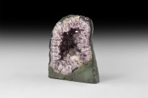 Natural History - Amethyst Crystal Cathedral
. An amethyst cathedral with polished face, accessory calcite, composition base. 3.4 kg, 18cm (7"). From...