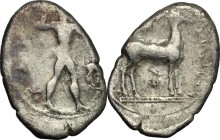 Greek Italy. Bruttium, Kaulonia. AR Drachm, 450-445 BC. D/ Apollo advancing right, holding branch; to right, stag standing right. R/ Stag standing rig...