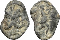 AE Tessera, c. 1st century AD. D/ Head of Janus, laureate. R/ Mars (?) advancing right and carrying trophy. AE. g. 3.33 mm. 21.00 VF/About VF.