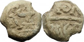 PB Tessera, c. 1st century AD. D/ Figure standing left, holding wreath. R/ Inscription (?). PB. g. 4.72 mm. 14.00 About VF.