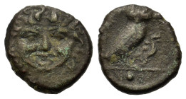 Sicily, Kamarina, c. 420-405 BC. Æ Onkia (11,6mm, 1.2g). Facing gorgoneion. R/ Owl standing r., head facing, grasping lizard in talons; Γ to r.; pelle...