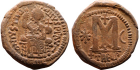 Justinian I (527-565) Follis. Antioch . Obverse: Justinian on throne. Reverse: Large Large M and Cross. THEUP