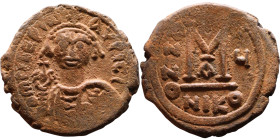 Maurice Tiberius (582-602) Follis. Obverse: Helmeted and cuirassed bust facing, holding globus cruciger and shield., Reverse: Large M above cross, ANN...