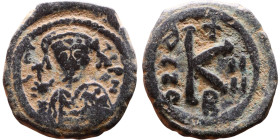 Maurice Tiberius (582-602) Half Follis. Obverse: Helmeted and cuirassed bust facing, holding globus cruciger and shield., Reverse: Large K above cross...