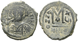 Byzantine Maurice Tiberius, 582-602. Follis , Nicomedia, 586-587. D N MAVRIC TIbЄRI P Helmeted and cuirassed bust of Maurice Tiberius facing, holding ...