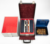 Coin supplies - Seven empty Lindner boxes diff. models, a metal money box, two Euro-Watches (1 & 2 €) and an artificial leather case with 4 Lindner bo...