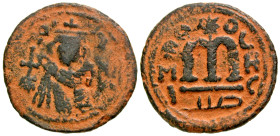 Arab-Byzantine, Umayyad Caliphate. Contemporary Imitation. AE follis (20.8 mm, 3.11 g, 10 h). Hims (Emesa) mint. Facing Umayyad Imperial bust / EMI to...