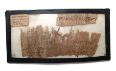 A pair of Papyrus fragments bearing ancient text, 3rd - 4th Century A.D. Both are framed within a back-bordered mount, the first a large fragment with...
