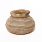 A nice Bactrian alabaster jar, 3rd - 2nd Millenium B.C. , of shallow piriform in shape with flattened base and flared rim. Carved from attractive, ban...