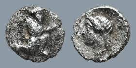 CILICIA. Uncertain mint. (4th Century BC)
AR Tetartemorion (5,8mm 0,18g)
Obv: Persian Great King kneeling-running to right, holding a dagger in his ...