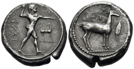 BRUTTIUM. Kaulonia. Circa 475-425 BC. Stater (Silver, 20 mm, 7.70 g, 1 h). Apollo, nude, walking to right, holding laurel branch in upright right hand...