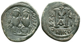 Justin II, 565 – 578Follis, Nicomedia 569-570, Æ. Justin and his wife Sophia, seated facing on throne: the Emperor holds globus cruciger , Sophia a cr...