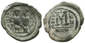 Justin II, 565 – 578Follis, Nicomedia 569-570, Æ. Justin and his wife Sophia, seated facing on throne: the Emperor holds globus cruciger , Sophia a cr...