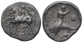 Calabria,Tarentum. AR Stater, 7.82 g 22.08 mm. Ca. 340-335 BC.
Obv: Two horses walking to the left; on the first, nude ephebe seated left, both hands...