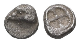 Ionia, Magnesia ad Maeandrum (?).AR Tetartemorion, 0.13 g 4.86 mm. Circa 500-464 BC.
Obv: Head of an eagle to left.
Rev: Wheel of four spokes within c...