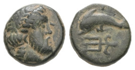 Caria, Nysiros or Myndos. Ae, 1.14 g 10.21 mm. Mid 4th-late 3rd century BC.
Obv: Laureate head of Zeus right.
Rev: Dolphin swimming left; below, tride...