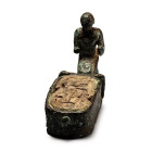 New Kingdom, circa 13th century B.C. Hollow-formed representation of a cartouche featuring a figure of a kneeling offerant at one end; the cartouche i...