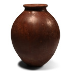 Naqada II, 3500-3150 B.C. A globular-shaped body with a disc base, short neck, and everted rim at the mouth; featuring a burnished red wash surface. C...
