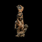 Late Period, 664-332 B.C. Isis enthroned wearing a cow's horn headdress with a solar disc fronted by uraeus, suckling the infant Horus on her lap; Hor...
