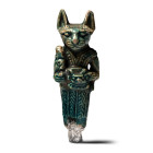Late Period, circa 664-332 B.C. Modelled in advancing pose wearing a tight-fitting robe, cat-headed, with a sistrum in one hand and a Bes head emblem ...