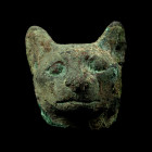 Late-Ptolemaic Period, 664-30 B.C. The head of goddess Bastet modelled in the round with alert ears and eyes, ears pierced; hollow-formed. Cf. Roeder,...