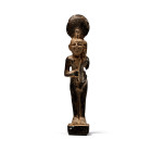 Late Period, 664-332 B.C. Carved in the round, the nude standing figure of the god sporting a solar disc and uraeus headdress, wearing a sidelock, and...