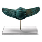 Late Period, 7th-6th century B.C. Comprising a crescentic plaque with central scarab modelled in the half-round, and lateral wings with hatched textur...