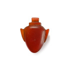 New Kingdom, 1550-1070 B.C. A large heart, ib, amulet of classic egg-form with shallow lugs on either side with short flared top and tubular suspensio...