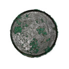Circa 6th century B.C. Discoid with raised beaded rim, obverse slightly convex with a guilloche border; the reverse with a central five-petalled flowe...