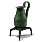 6th century B.C. Pear-shaped body with rounded base, raised circumferential hoop at the neck and everted rim; applied high, ribbed handle with an engr...