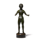 6th-4th century B.C. Youthful male standing wearing a belted tunic with apron, arms spread wide, barefoot, bare-headed with short textured hair; mount...