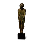 4th-2nd century B.C. Standing with arms held straight at the sides, short hair with neck-ring to rear, short-sleeved tunic with pleats to centre-front...