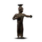 6th-3rd century B.C. Modelled in the round standing and wearing ankle-length robe, helmet with flared crest; left arm extended and right arm bent as i...