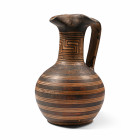 Geometric Period, 7th-6th century B.C. With a bulbous body and low basal ring, tubular neck with pinched trefoil spout and a wide strap handle to the ...