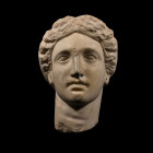 3rd century B.C. Carved in the round with flat angled panel to upper and rear of head; stern female features with deep-set eyes and small pursed lips;...